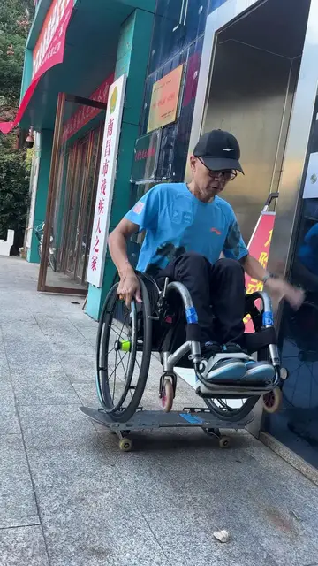 Video thumbnail for Wheelchair Athlete Rolling on a Modified Skateboard