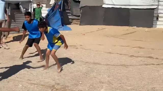 Video thumbnail for Gazans play their own "World Cup" at stadium-turned shelter.