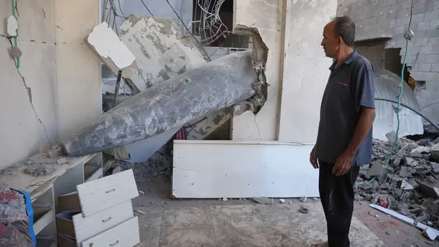 'Video thumbnail for Gaza family forced to live around undetonated bomb lodged in their home'