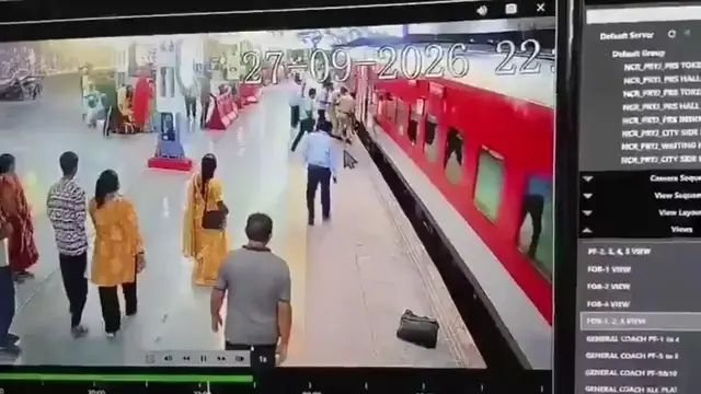 Video thumbnail for India: Woman plunges beneath moving train after losing balance at platform, quickly rescued.