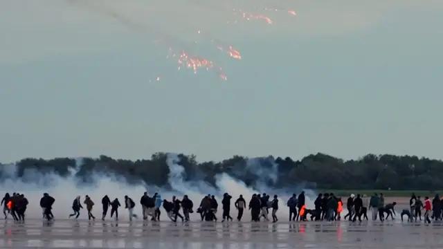 Video thumbnail for French police fire tear gas at migrants on beach