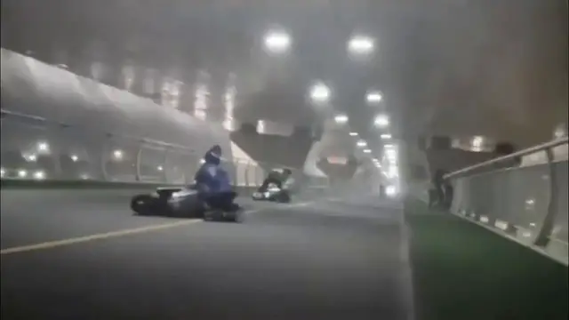 Video thumbnail for China: Cyclists caught in a storm on a bridge.