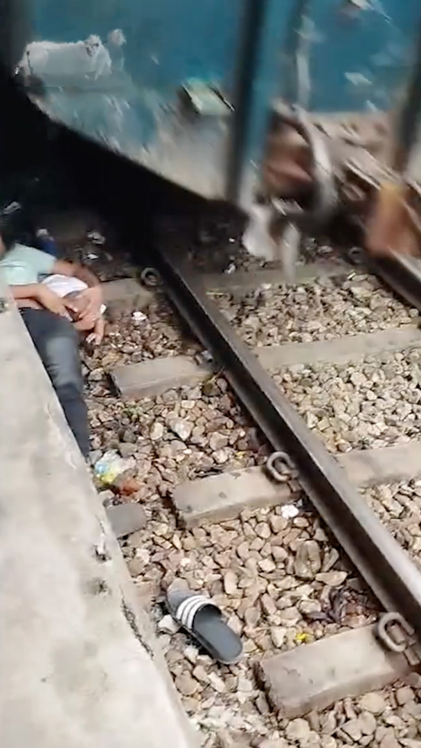 Video thumbnail for Dramatic video shows father shielding infant under moving train in Bangladesh
