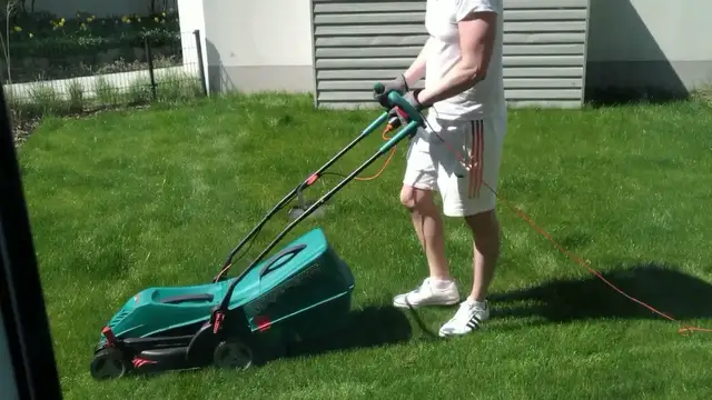 Video thumbnail for Man At Chores: Mowing Beautiful Green Garden Lawn