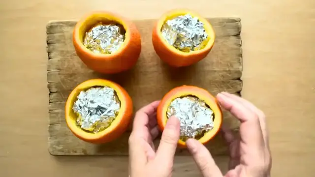 'Video thumbnail for She stuffs silver foil into orange peels for this GENIUS window idea!'