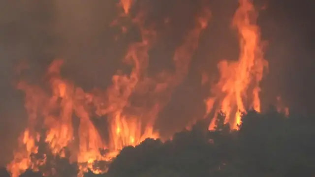 Video thumbnail for Greece: Wildfires rage across Greece as strong winds hamper firefighting efforts to save coastal resort.