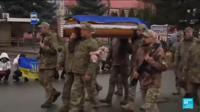 'Video thumbnail for In Ukraine, families line the streets for a funeral march in the freezing rain'