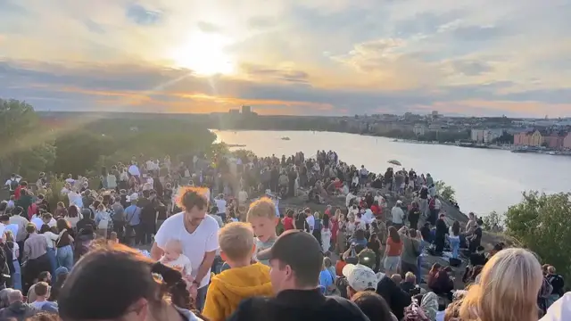 Video thumbnail for Sweden: Crowds in Stockholm gather in open area to observe partial solar eclipse.