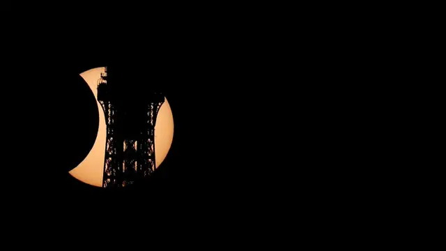 Video thumbnail for Solar eclipse carves Eiffel Tower’s silhouette in Paris sky