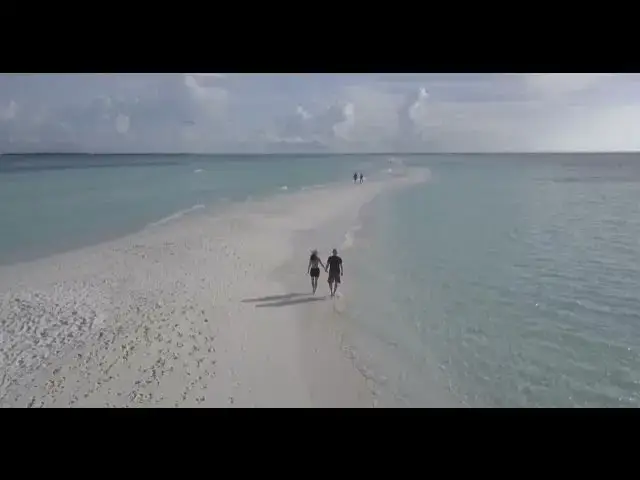 Video thumbnail for Couple Walking on a Beach Filmed with a Drone