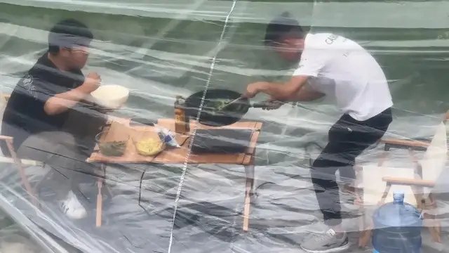 Video thumbnail for China: Chinese men camp with car air conditioning under plastic cover.