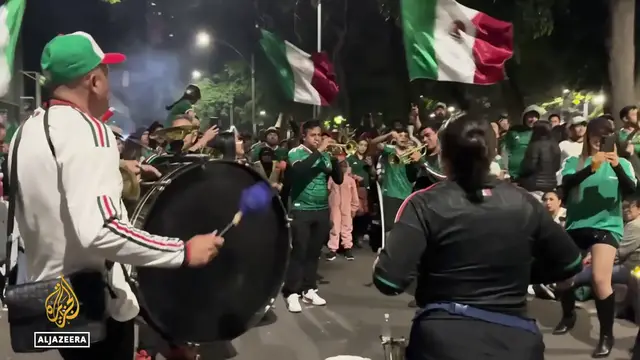 Video thumbnail for Mexico's world cup passion: Fans embrace tournament as team reaches last 16
