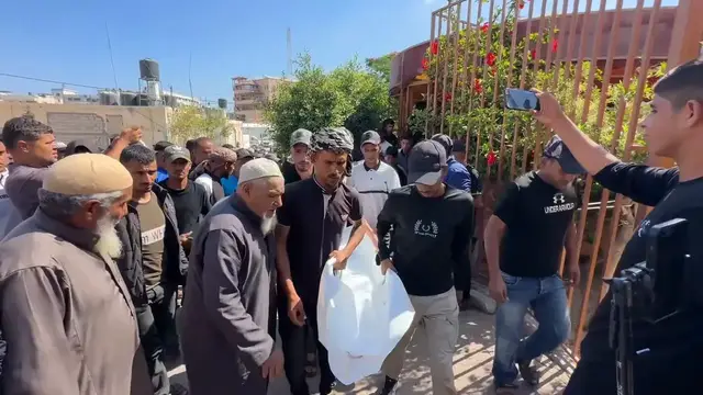 Video thumbnail for Funeral held for 3 Palestinians killed in Israeli strike in southern Gaza.