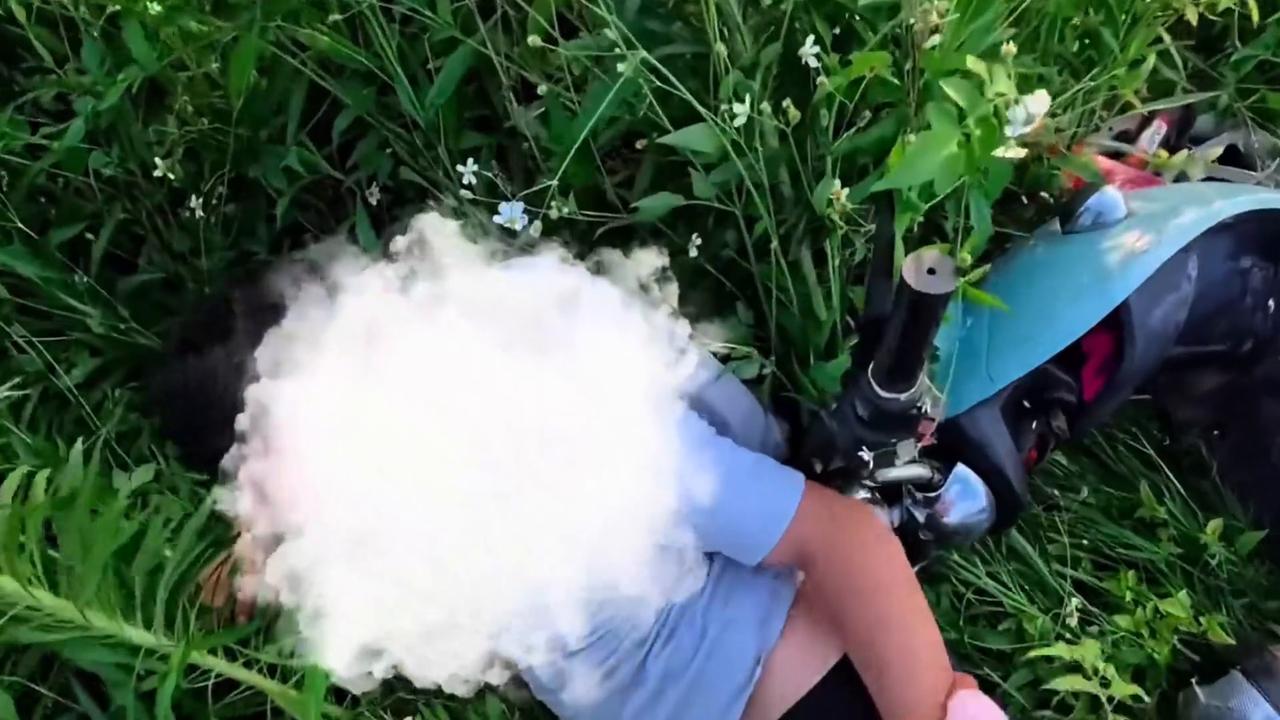 Video thumbnail for China: Chinese man falls into roadside grass while warning cyclist about a cat.