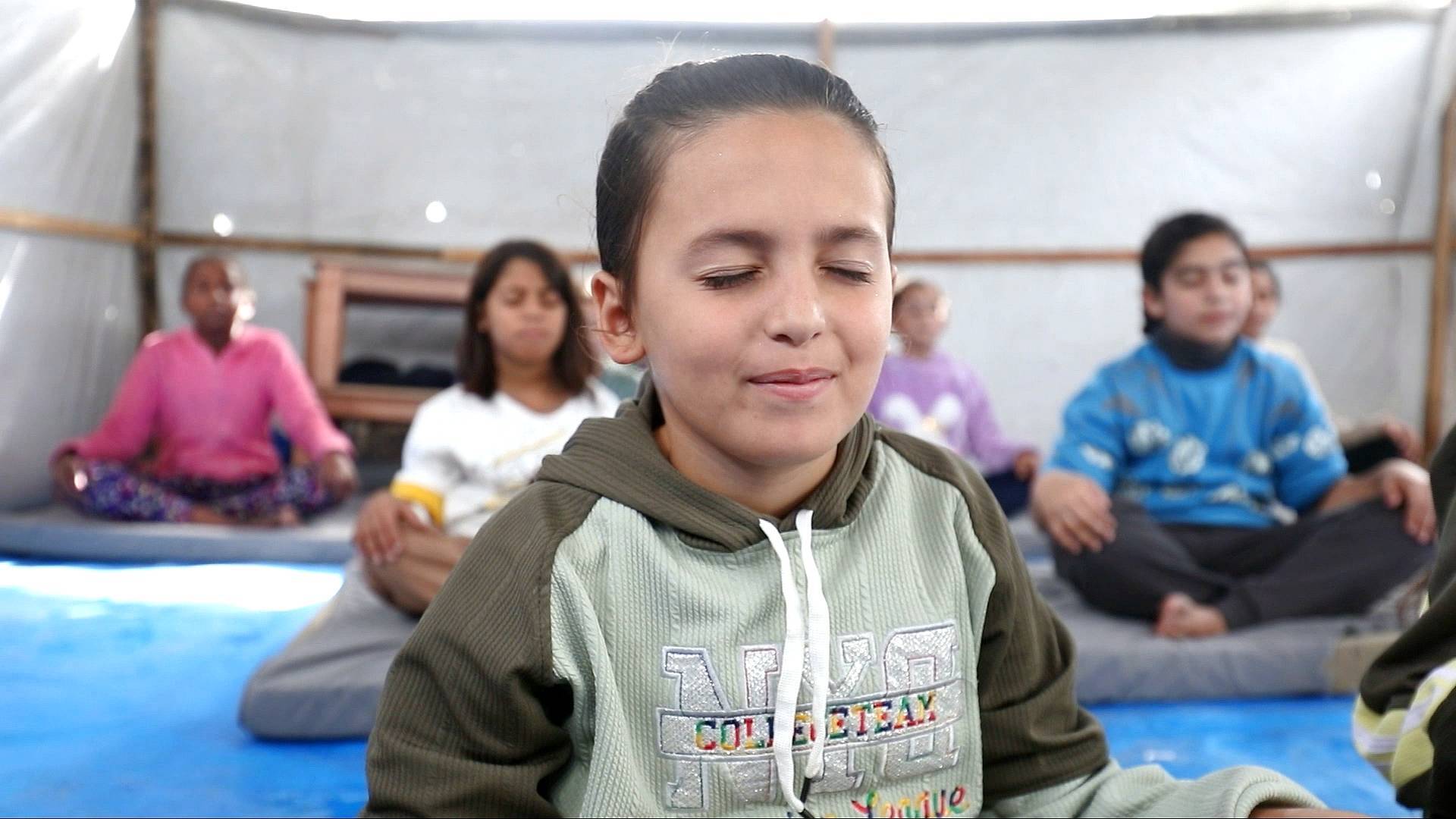 Video thumbnail for Gaza children learn yoga to heal from war trauma and find joy