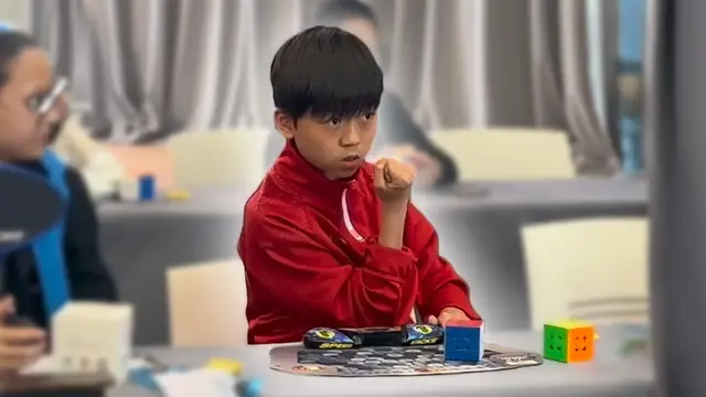 Video thumbnail for 11-year-old sets fastest average time to solve a 3x3x3 cube