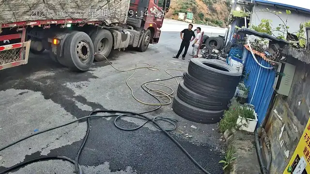 Video thumbnail for China: Chinese truck tire blows up seconds after workers hear warning sound.