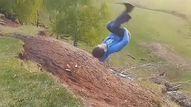 Video thumbnail for Boy Attempts Backflip Off Hillside and Laughs After Fall