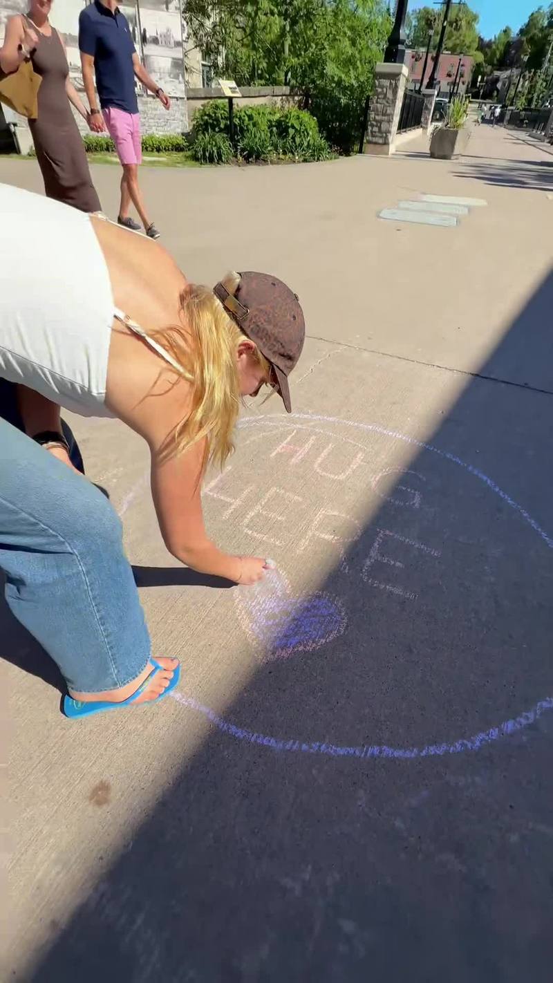 Video thumbnail for Sidewalk Chalk Hug Circle Brings Strangers Together