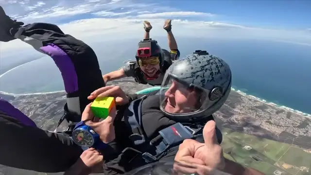 Video thumbnail for Fastest time to solve a rotating puzzle cube whilst in freefall