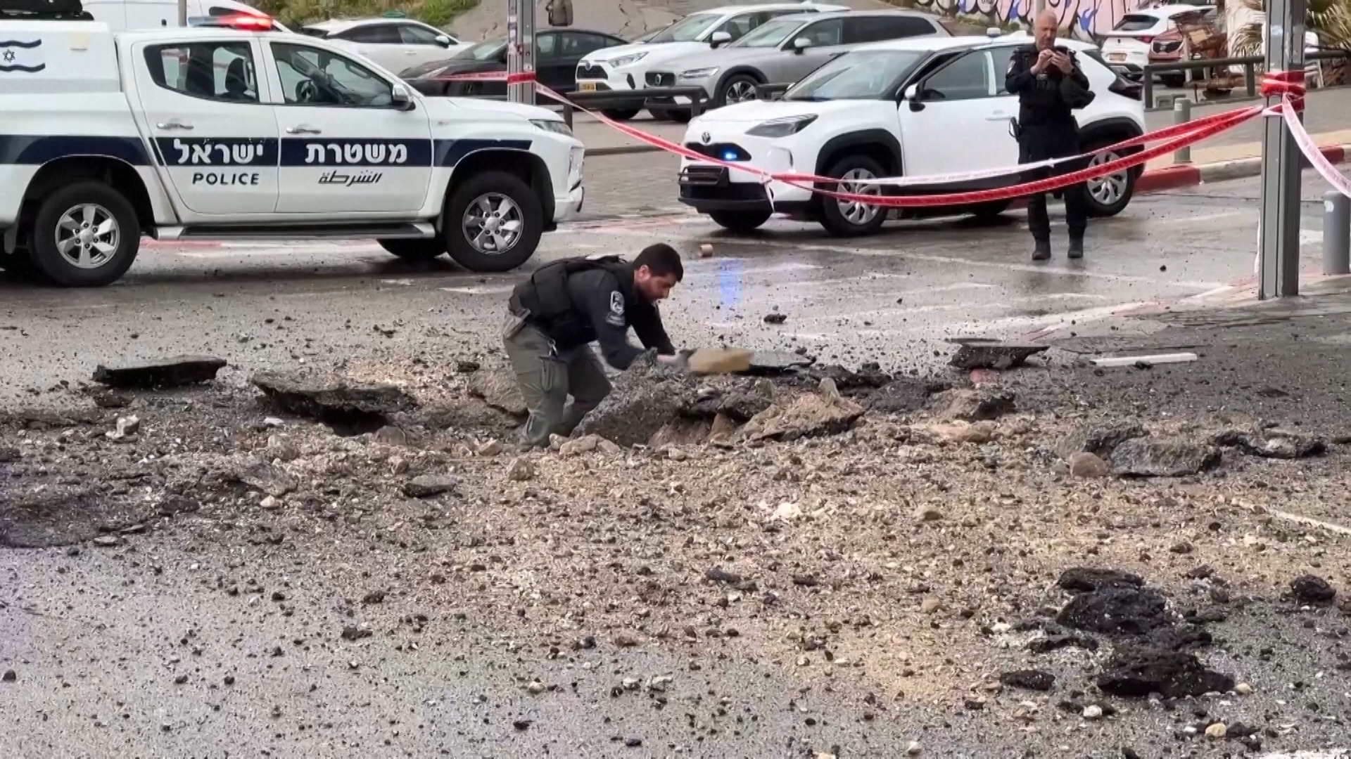 Video thumbnail for Israeli police inspect damage on the road after missile impact