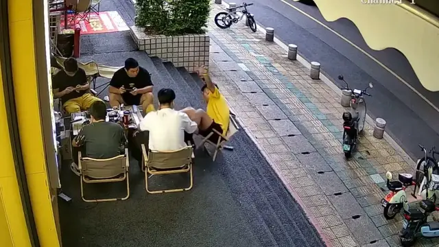 Video thumbnail for Man Tips Backward Off Chair Outside Gym in Fujian