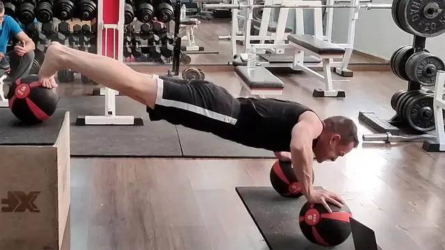 Video thumbnail for Most decline push ups on medicine balls in one minute (male) - 83 by George Kotsimpos