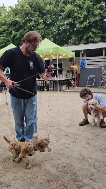 Video thumbnail for Dog Marionette Entertains a Curious Pup at Outdoor Festival