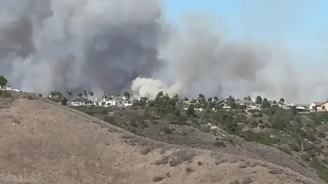 Video thumbnail for US: Wildfire Smoke Billows Right Behind Ridgetop Homes in San Clemente.