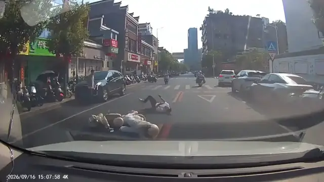 Video thumbnail for Pedestrian and E-Scooter Rider Collide After Sudden Road Crossing in Jiangxi