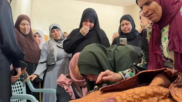Video thumbnail for Palestine: Mourners gather in West Bank for funeral of Palestinian killed in Israeli raid.