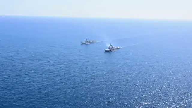Video thumbnail for US: Newest U.S. Navy Destroyer Sails Alongside USS Daniel Inouye Off San Diego.