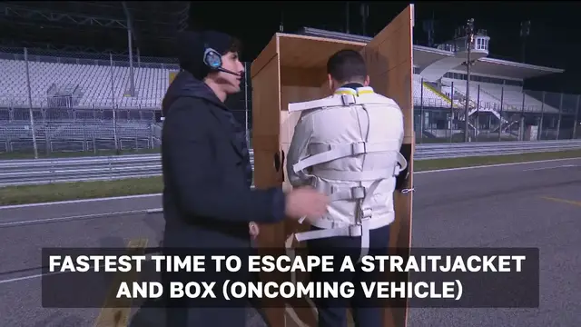 Video thumbnail for Fastest time to escape a straitjacket and box (oncoming vehicle)