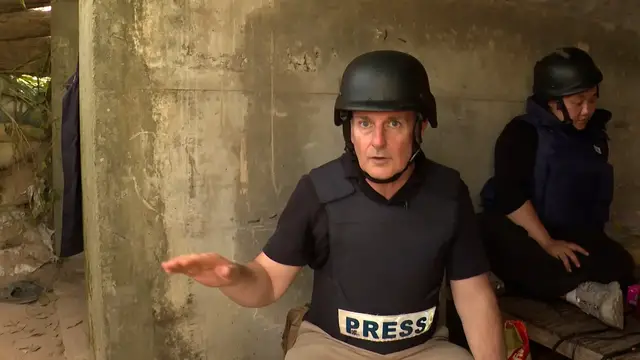 Video thumbnail for Al Jazeera reporter takes shelter amid shelling at Thai-Cambodia border