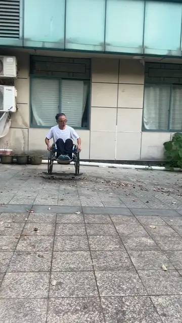 Video thumbnail for Wheelchair Ride across the Courtyard on a Skateboard