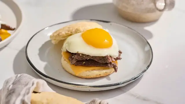 'Video thumbnail for This Steak And Cheese Biscuit Recipe Brings Extra Comfort To Brunch'
