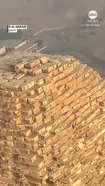 Video thumbnail for A man flying high above Egypt's Great Pyramid of Giza in a powered paraglider spotted something unexpected on top of the ancient landmark a dog.