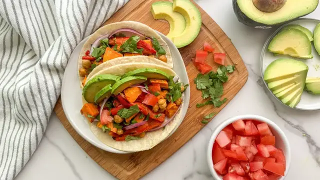 'Video thumbnail for Chile-Lime Sweet Potato And Chickpea Sheet-Pan Tacos Recipe'