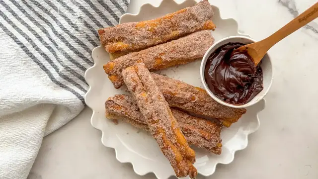 'Video thumbnail for Turn Store-Bought Pizza Dough Into Sweet And Chewy Churros With Our Recipe'